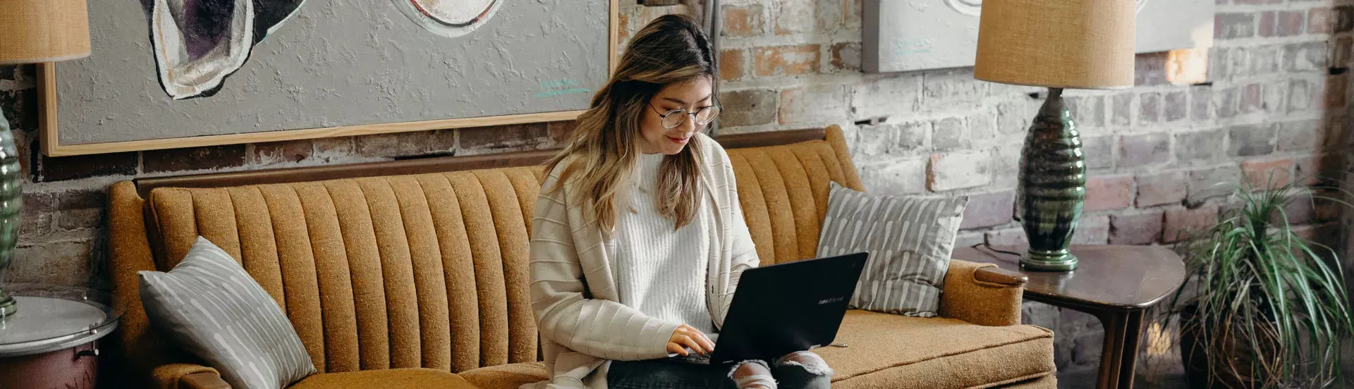 woman on her couch with a computer